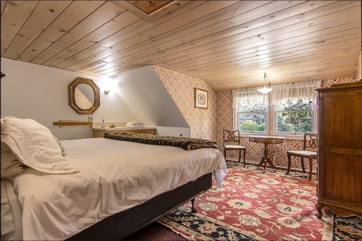 26770 Idyllwild Road Idyllwild, CA 92549 - Photo 16 of 52 a bedroom with a bed and wooden floor