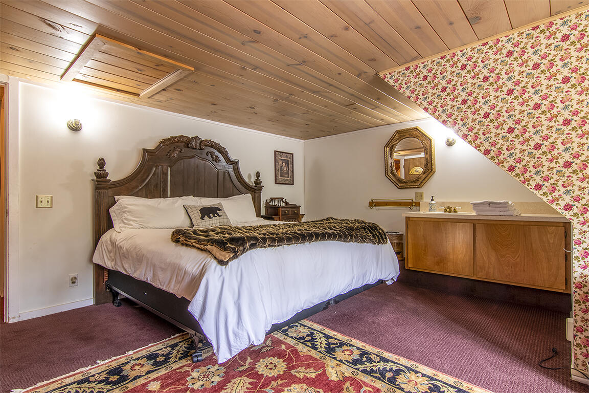 26770 Idyllwild Road Idyllwild, CA 92549 - Photo 17 of 52 a bedroom with a bed and a wall painting