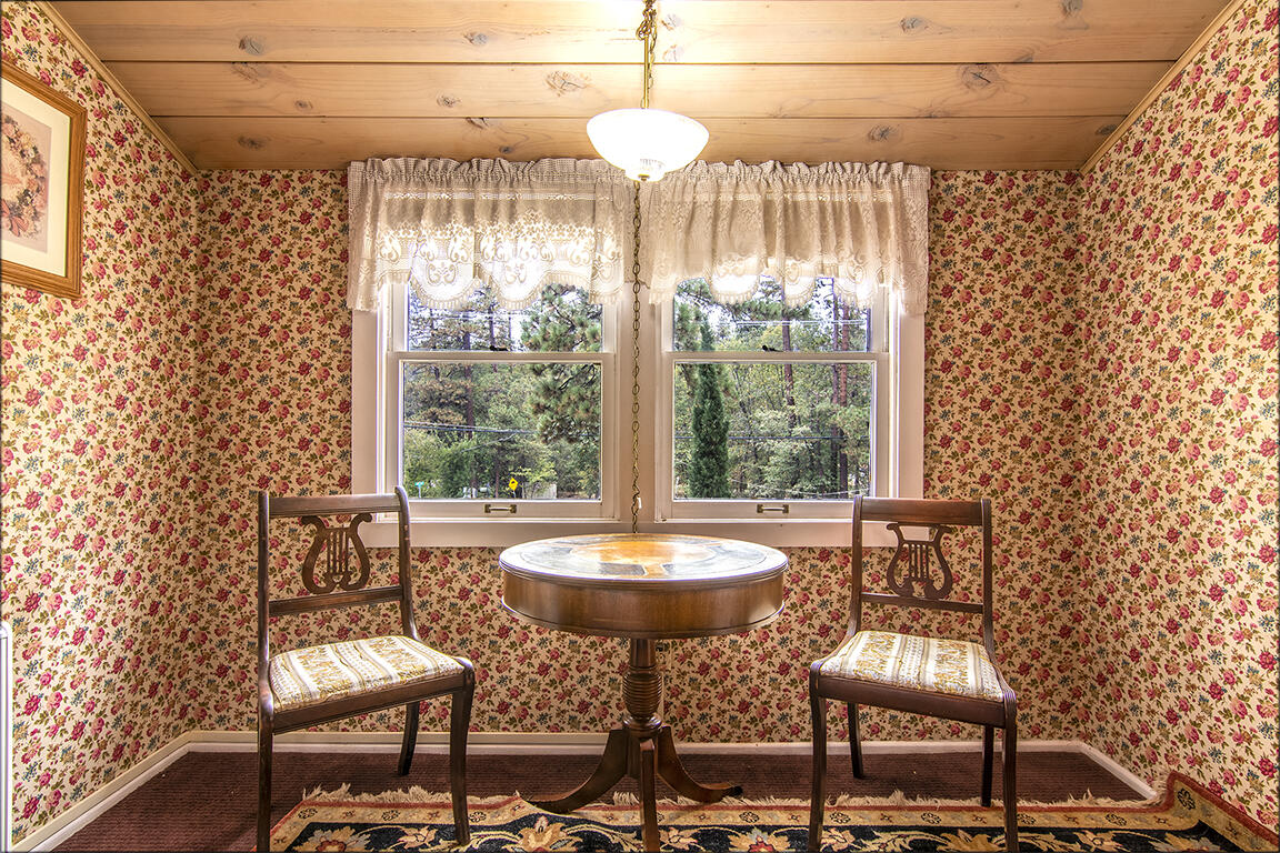 26770 Idyllwild Road Idyllwild, CA 92549 - Photo 18 of 52 a dining room with furniture and a floor to ceiling window