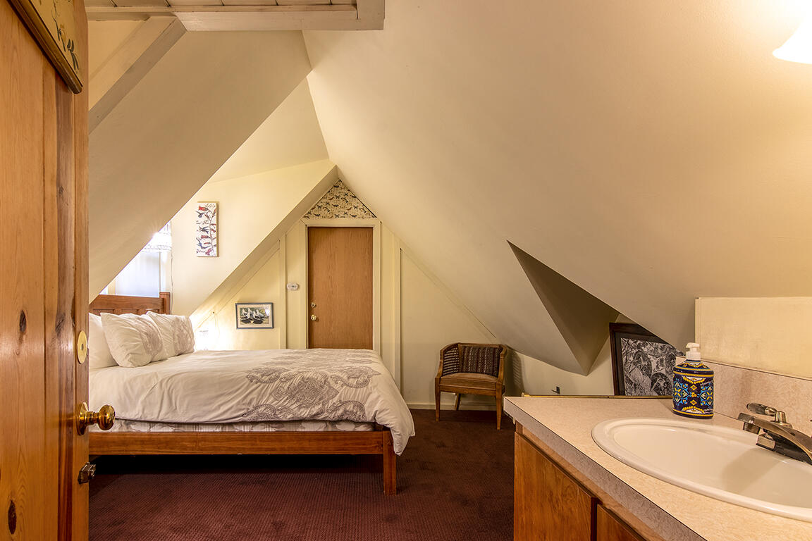 26770 Idyllwild Road Idyllwild, CA 92549 - Photo 24 of 52 a bedroom with a bed a dresser and potted plants