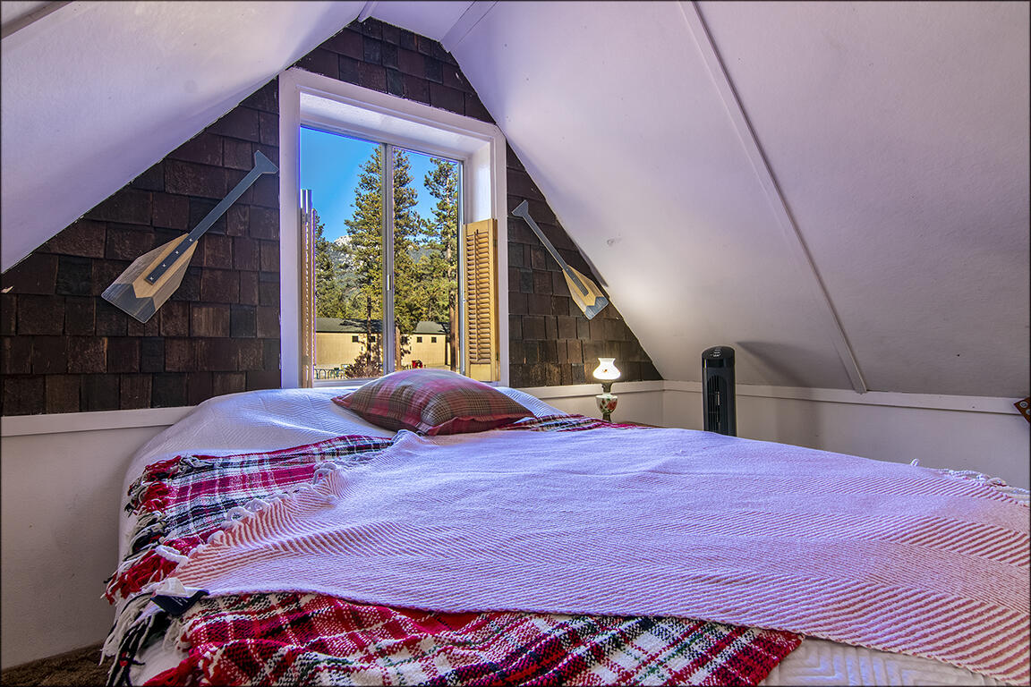 26770 Idyllwild Road Idyllwild, CA 92549 - Photo 35 of 52 a bedroom with a large bed and a large window
