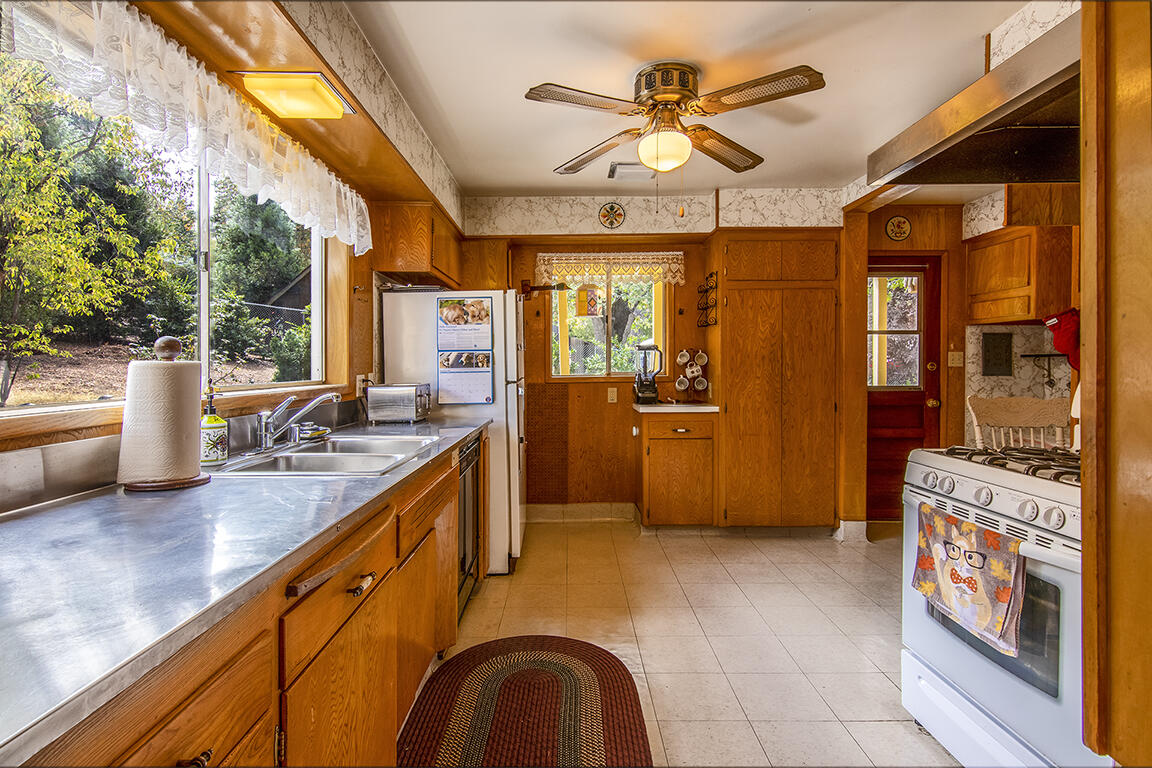 26770 Idyllwild Road Idyllwild, CA 92549 - Photo 5 of 52 a kitchen with stainless steel appliances granite countertop a sink a stove next to a window