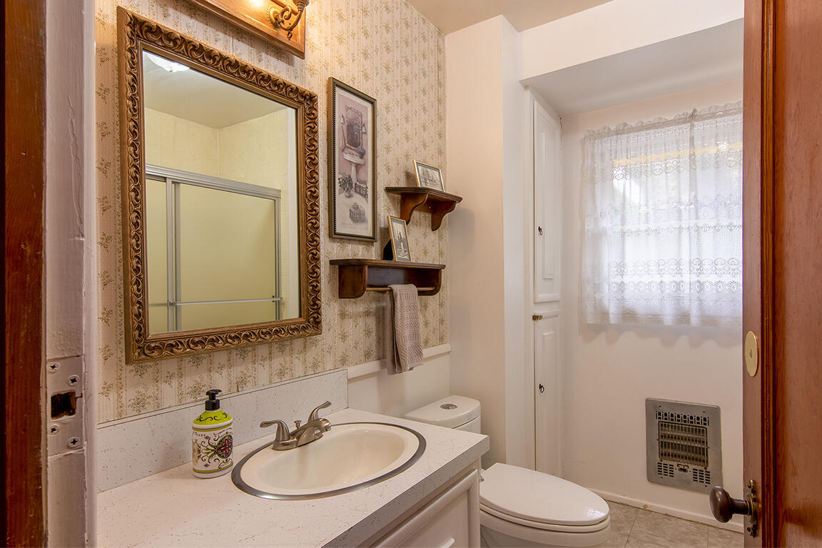 26770 Idyllwild Road Idyllwild, CA 92549 - Photo 8 of 52 a bathroom with a sink a toilet a mirror and shower
