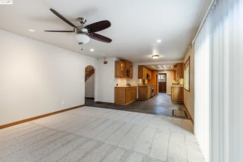 a view of a livingroom with a furniture and ceiling fan