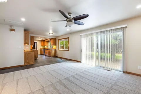 a view of a livingroom with a ceiling fan and window