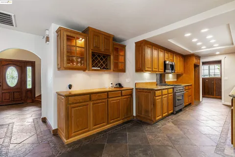 a kitchen with stainless steel appliances granite countertop a stove a sink and a refrigerator