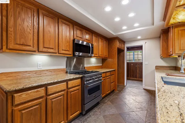 a bedroom with a bed chandelier and a window