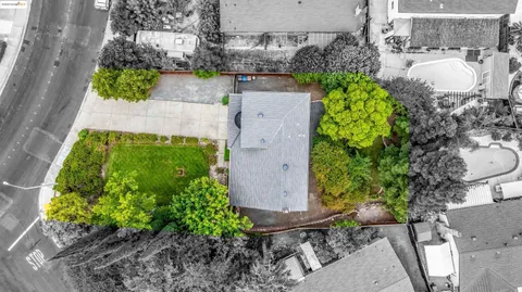 an aerial view of a house with a yard and garden