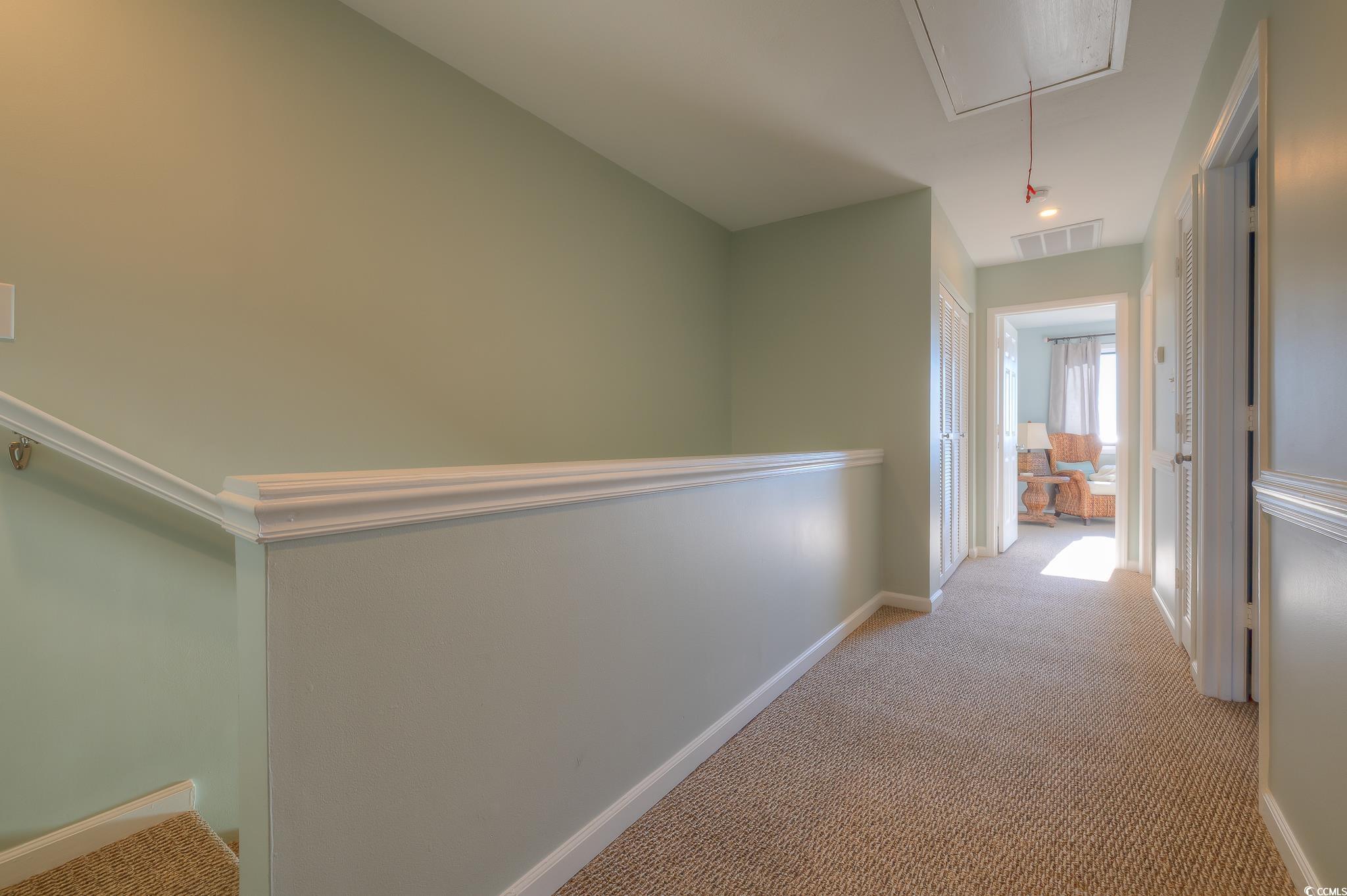 204 Bamboo Loop, Unit 202 Georgetown, SC 29440 - Photo 11 of 40 Corridor featuring light colored carpet and attic access