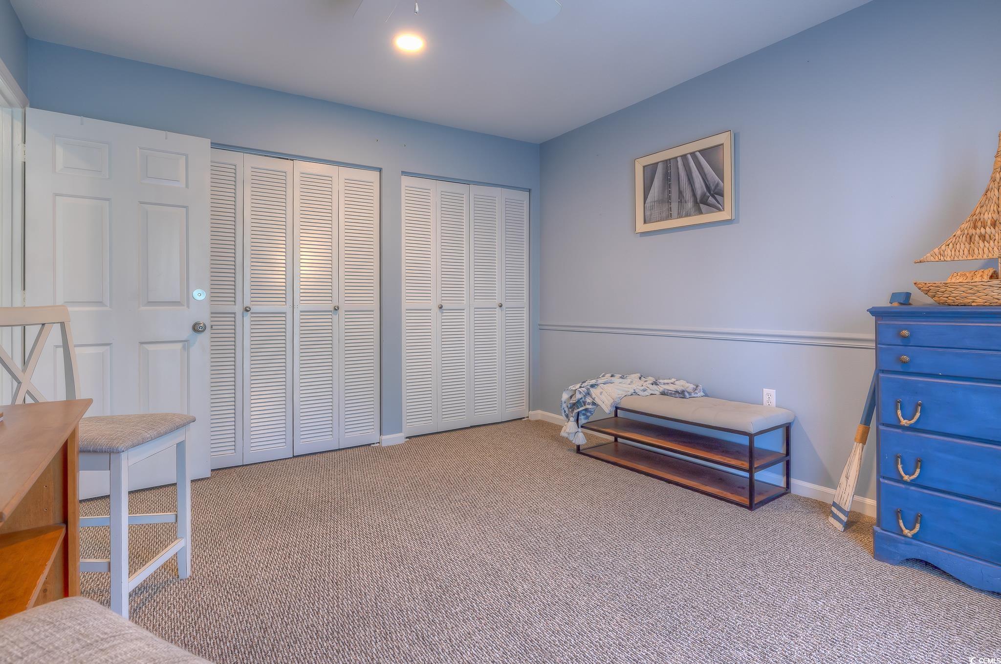 204 Bamboo Loop, Unit 202 Georgetown, SC 29440 - Photo 13 of 40 Carpeted bedroom featuring two closets and ceiling fan