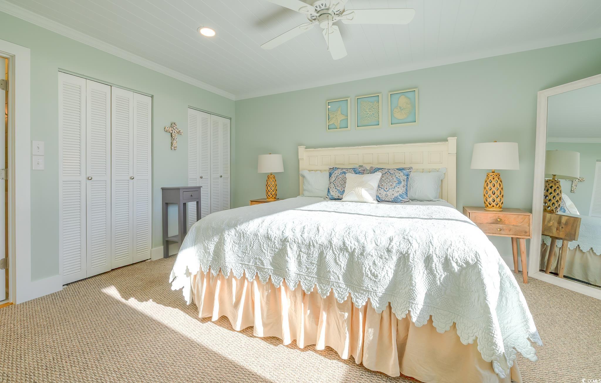 204 Bamboo Loop, Unit 202 Georgetown, SC 29440 - Photo 18 of 40 Carpeted bedroom featuring two closets, recessed lighting, ornamental molding, and ceiling fan