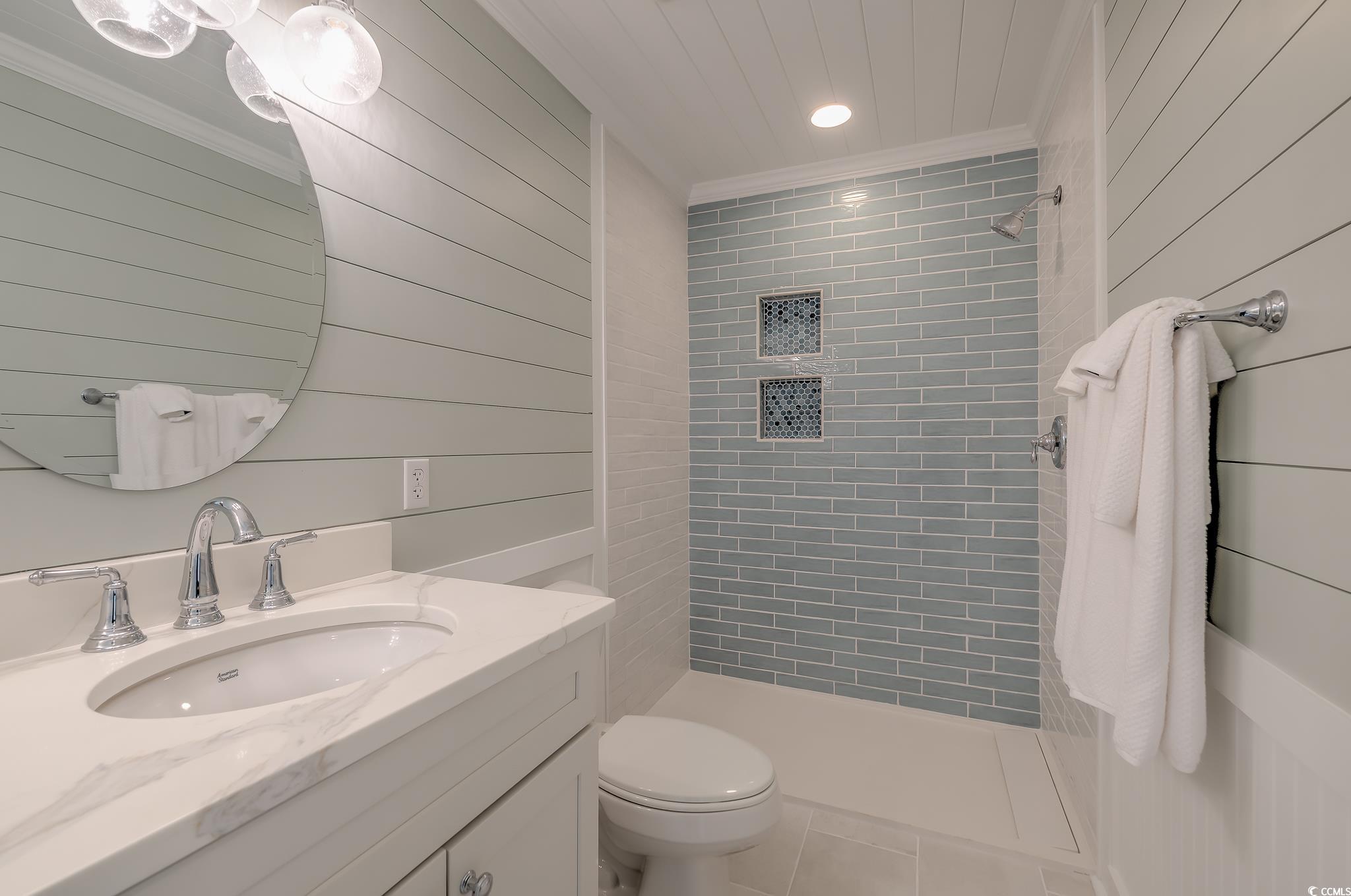 204 Bamboo Loop, Unit 202 Georgetown, SC 29440 - Photo 20 of 40 Full bath featuring vanity, recessed lighting, tile patterned flooring, a stall shower, and wooden walls