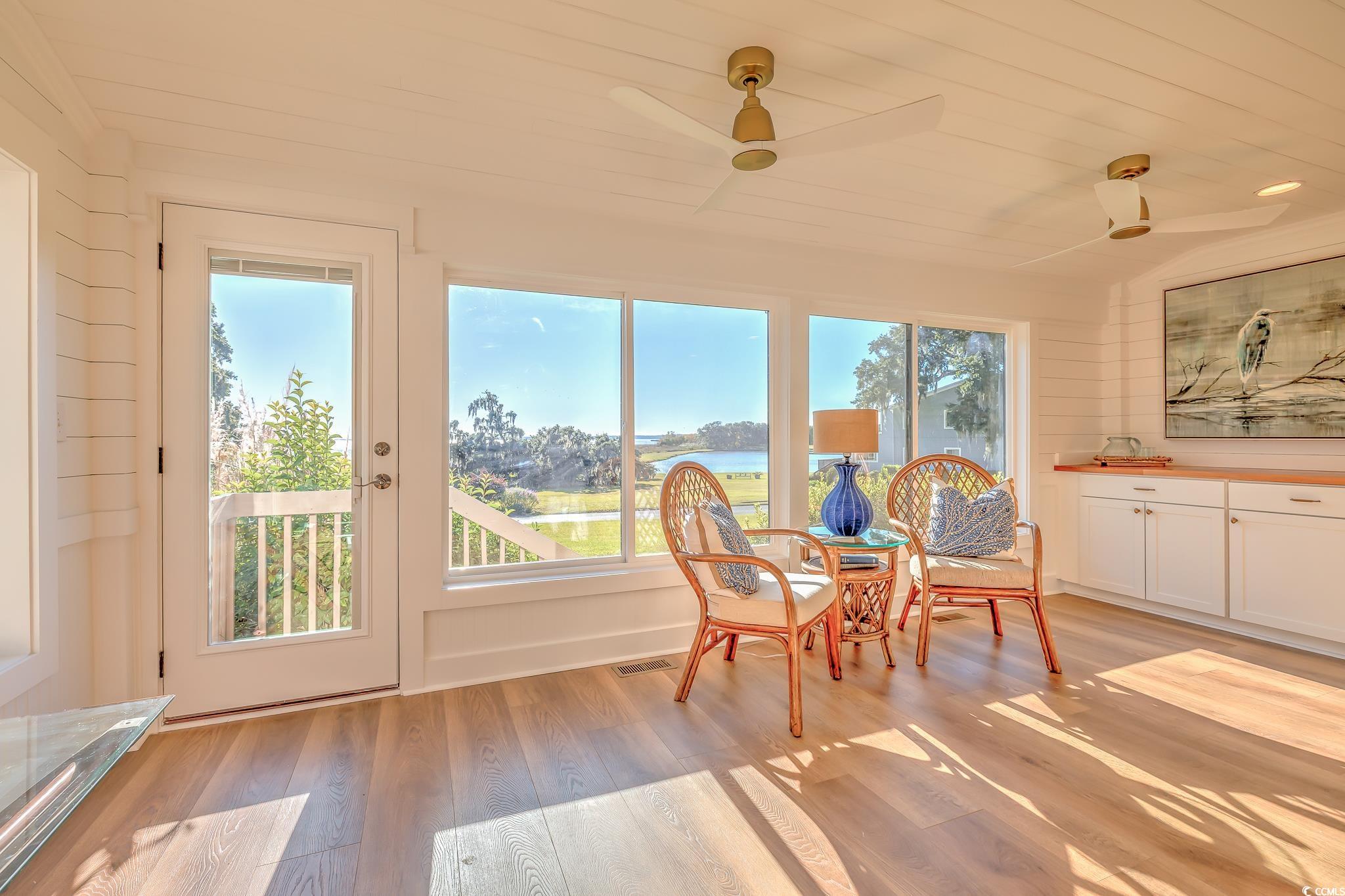 204 Bamboo Loop, Unit 202 Georgetown, SC 29440 - Photo 26 of 40 Sunroom with wood finished floors, a water view, and wooden ceiling
