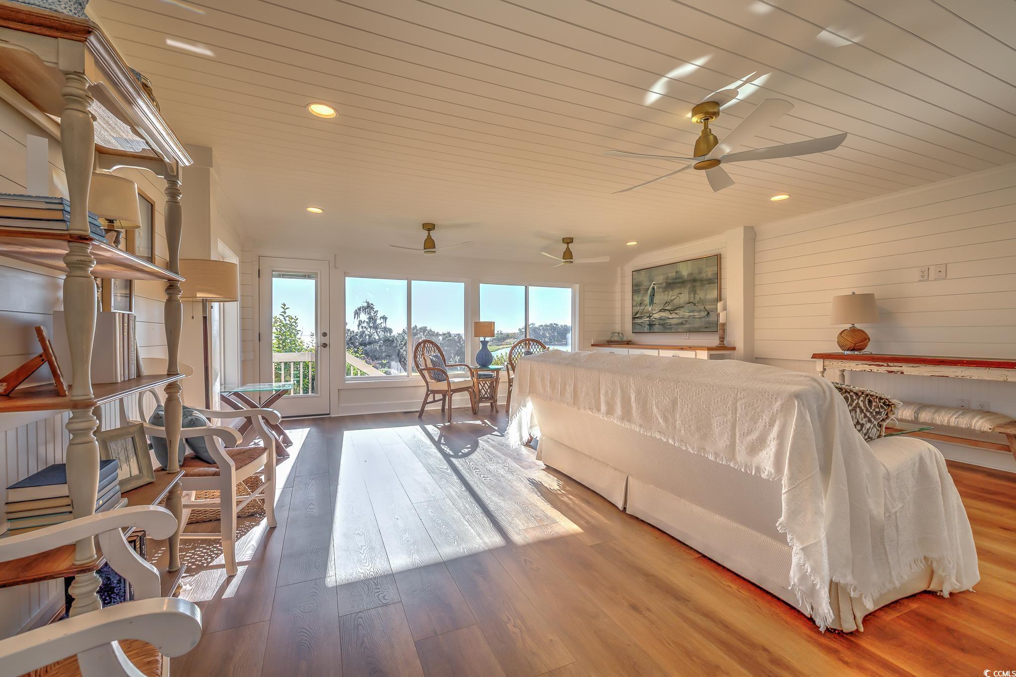 204 Bamboo Loop, Unit 202 Georgetown, SC 29440 - Photo 28 of 40 Bedroom featuring wood-type flooring, access to outside, recessed lighting, wooden ceiling, and wooden walls