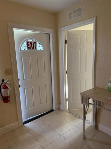 a view of a hallway with couch and painted walls
