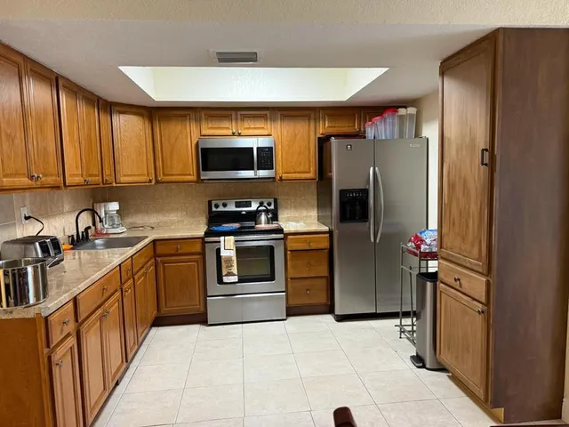 a house with green field in front of it