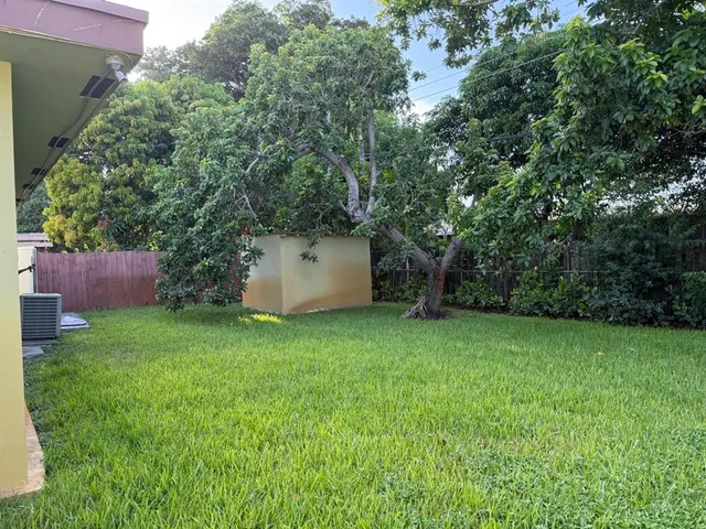 a backyard of a house with lots of green space