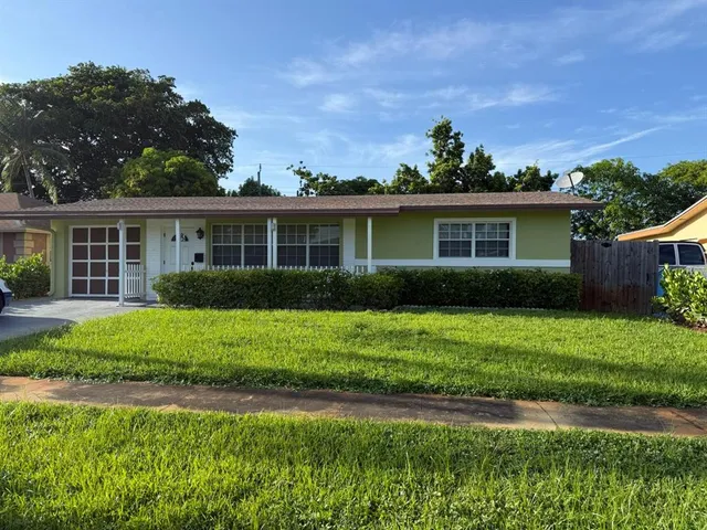 a backyard of a house with outdoor seating