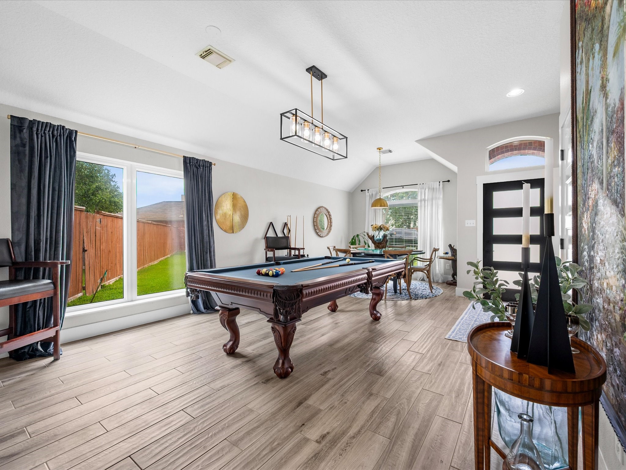 4023 Tigris Ridge Drive Katy, TX 77449 - Photo 9 of 39 Wood-look tile flooring flows seamlessly across the main living areas, offering both durability and refined style.