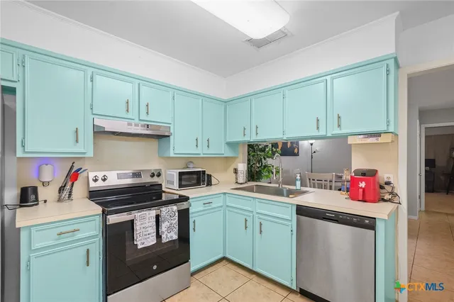 a utility room with cabinets washer and dryer