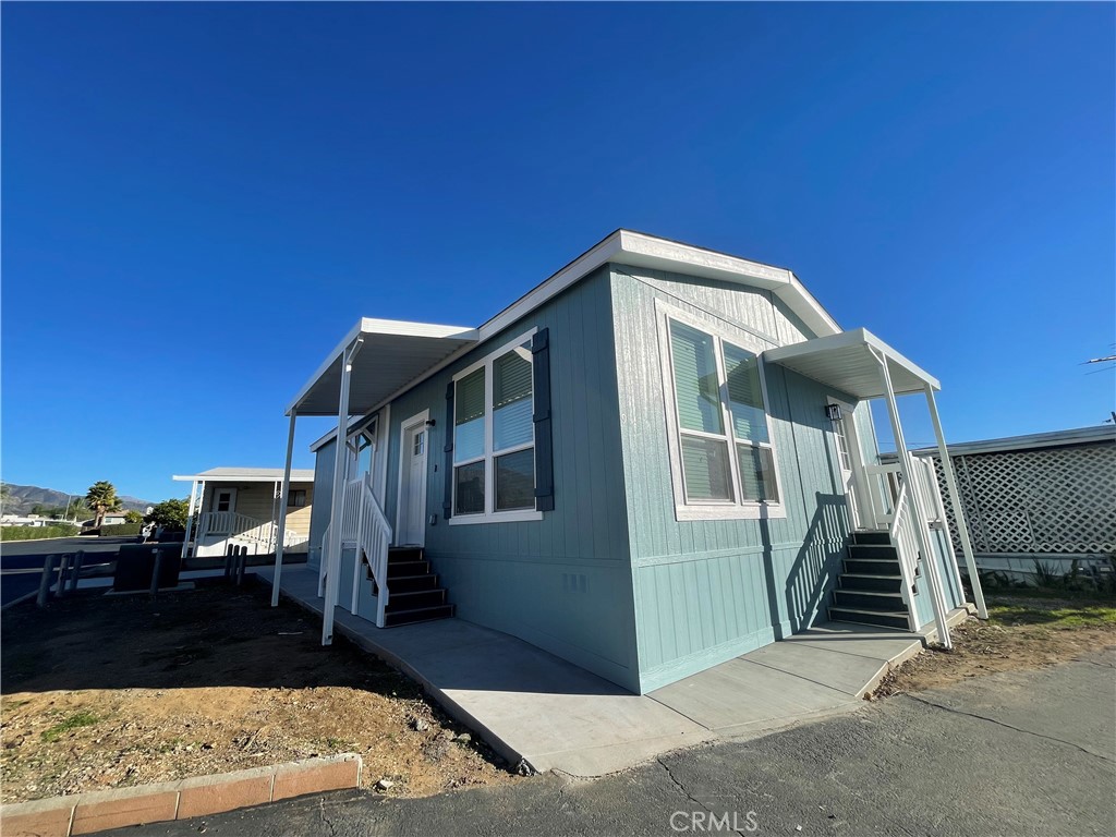 12995 6th Street, Unit 9 Yucaipa, CA 92399 - Photo 1 of 32 a front view of a house with a yard