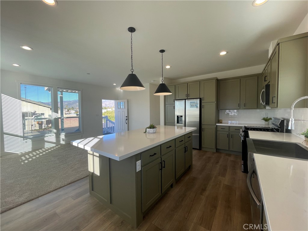 12995 6th Street, Unit 9 Yucaipa, CA 92399 - Photo 13 of 32 a kitchen with stainless steel appliances granite countertop a sink a stove and a refrigerator