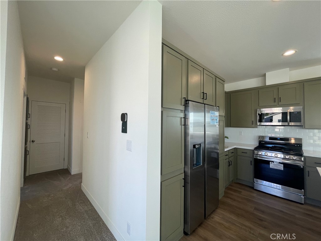 12995 6th Street, Unit 9 Yucaipa, CA 92399 - Photo 18 of 32 a kitchen with stainless steel appliances granite countertop a refrigerator and a stove