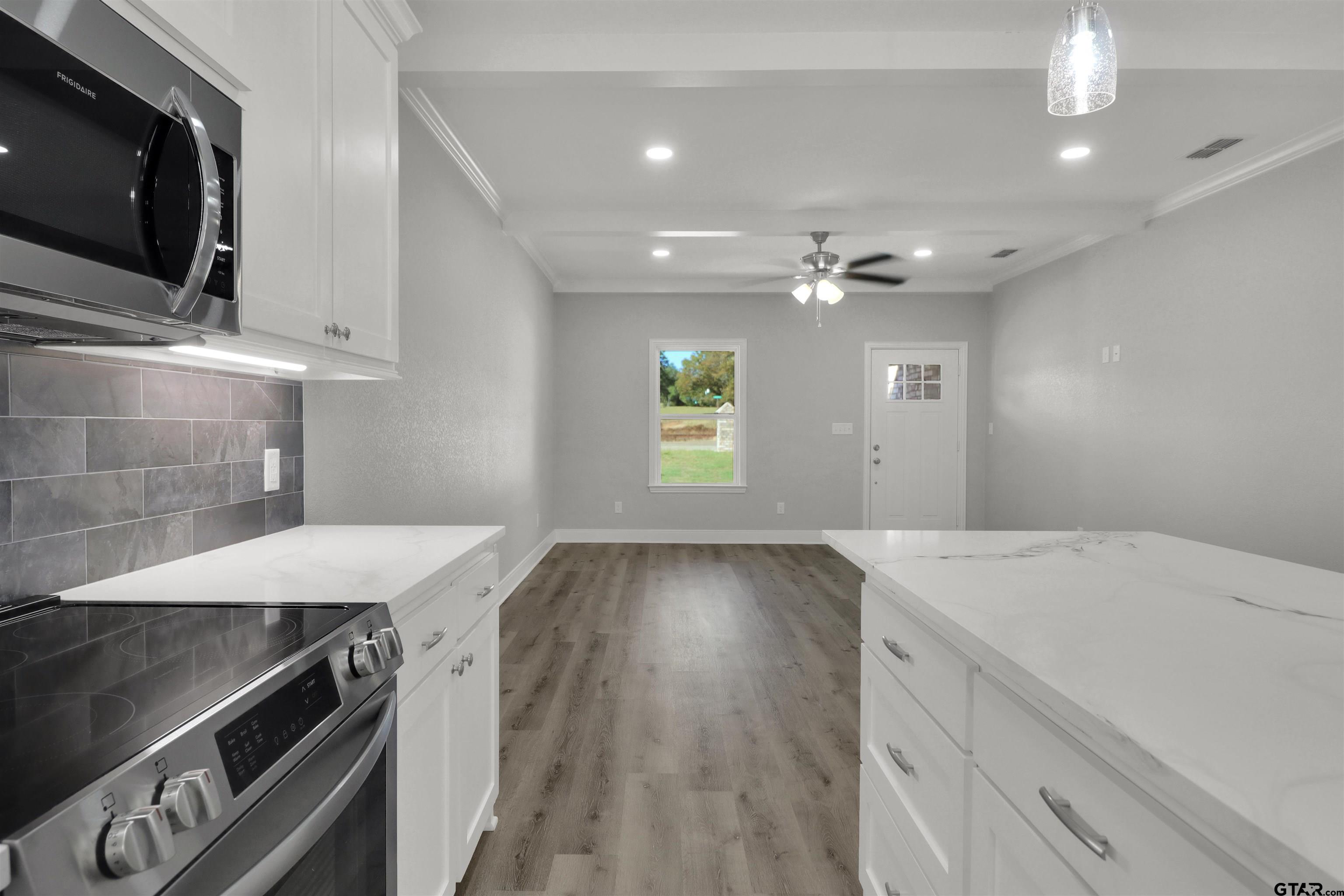 614 North Commerce Street Overton, TX 75684 - Photo 12 of 23 a kitchen with a sink stove and microwave