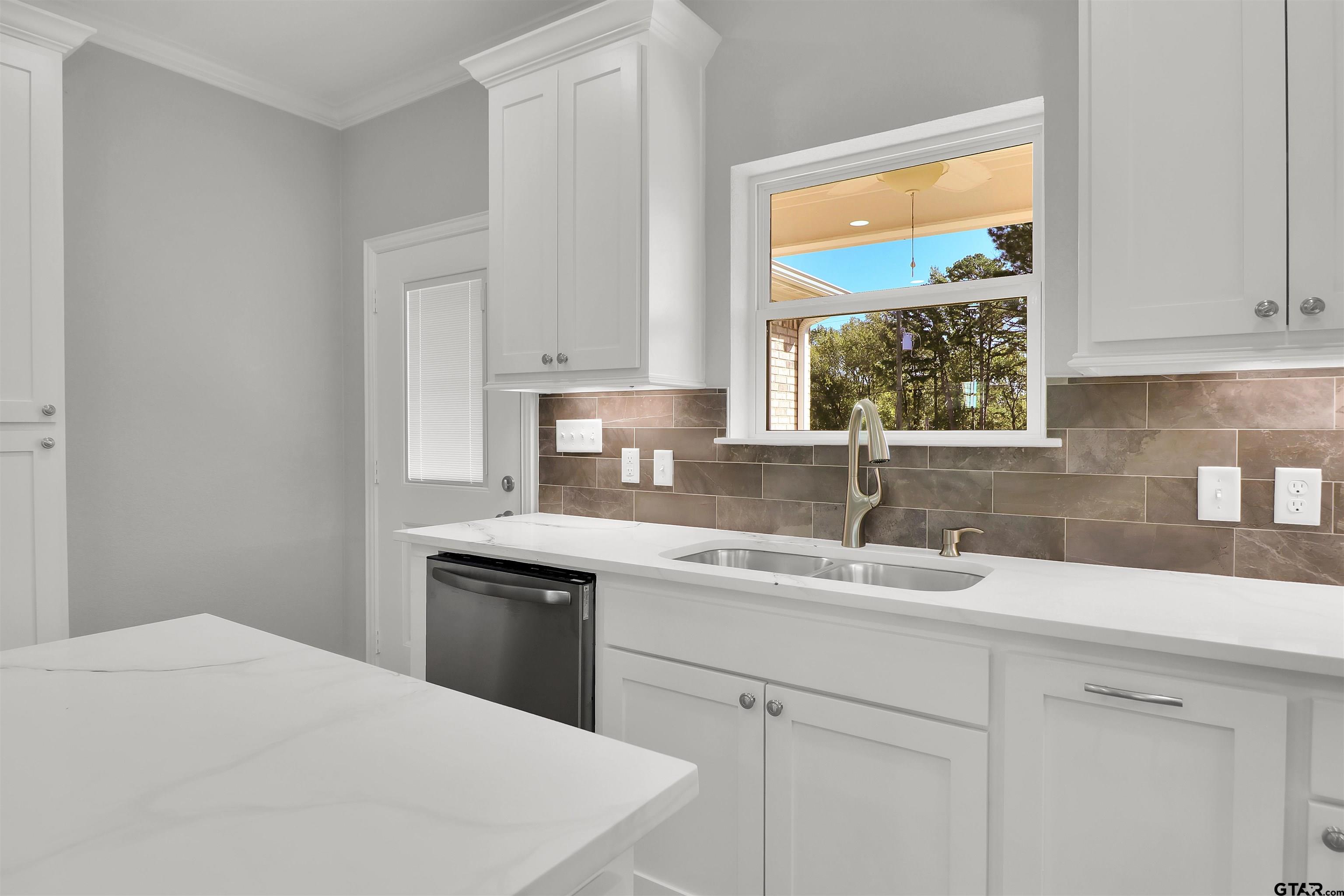 614 North Commerce Street Overton, TX 75684 - Photo 9 of 23 a kitchen with a sink stove and cabinets