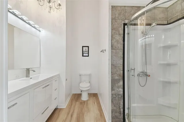 a bathroom with a double vanity sink toilet and shower