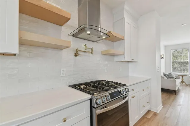 a stove top oven sitting inside of a kitchen
