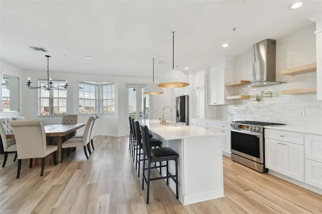 a large kitchen with a table and chairs