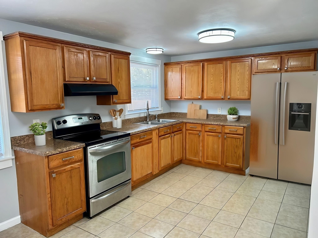 42 Talmadge Drive Springfield, MA 01118 - Photo 2 of 21 a kitchen with a stove sink and cabinets