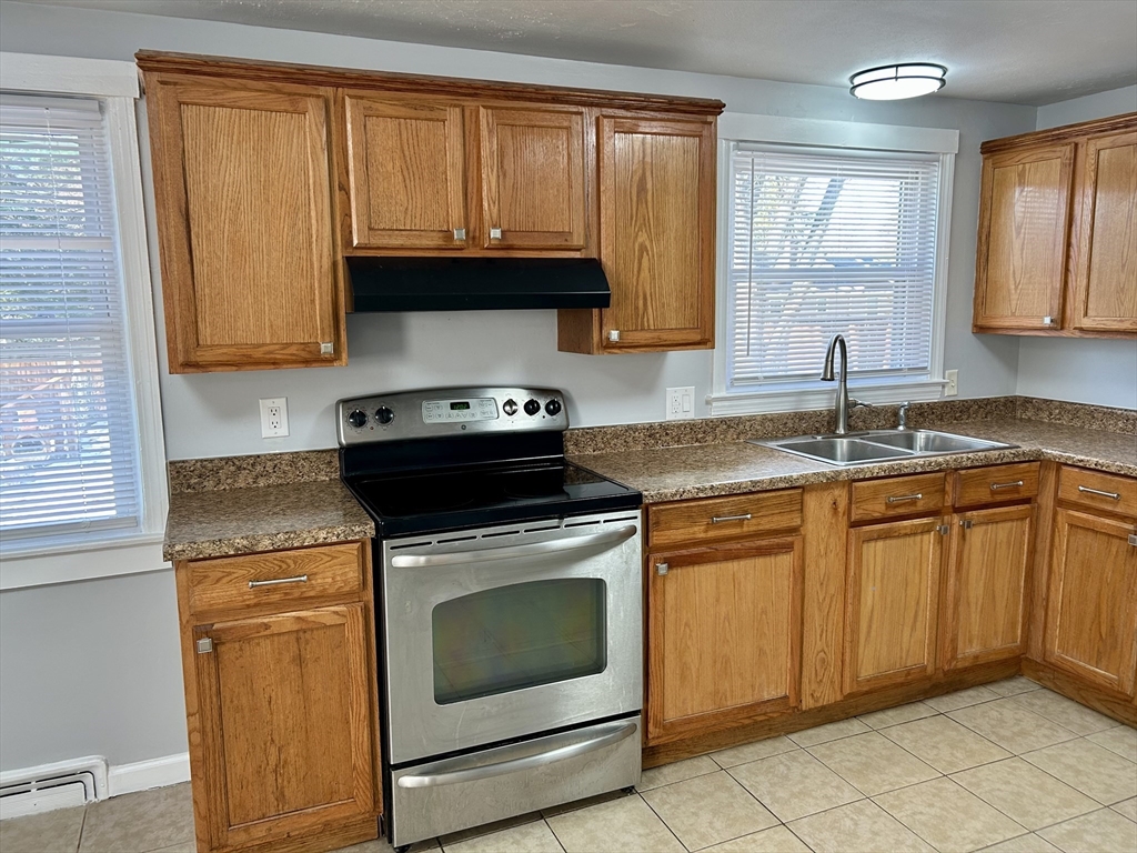 42 Talmadge Drive Springfield, MA 01118 - Photo 4 of 21 a kitchen with granite countertop stainless steel appliances a stove a sink and a microwave