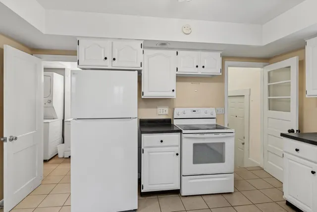 a white refrigerator freezer sitting inside of a kitchen