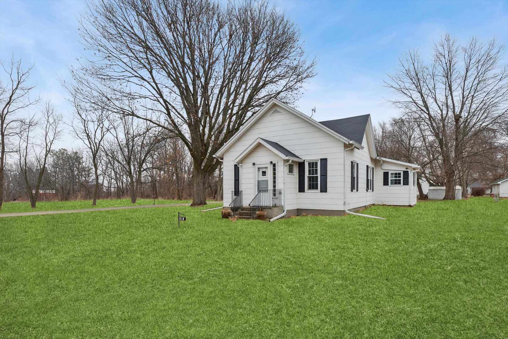 310 North Scott Street Alexis, IL 61412 - Photo 3 of 22 a front view of a house with a yard and trees