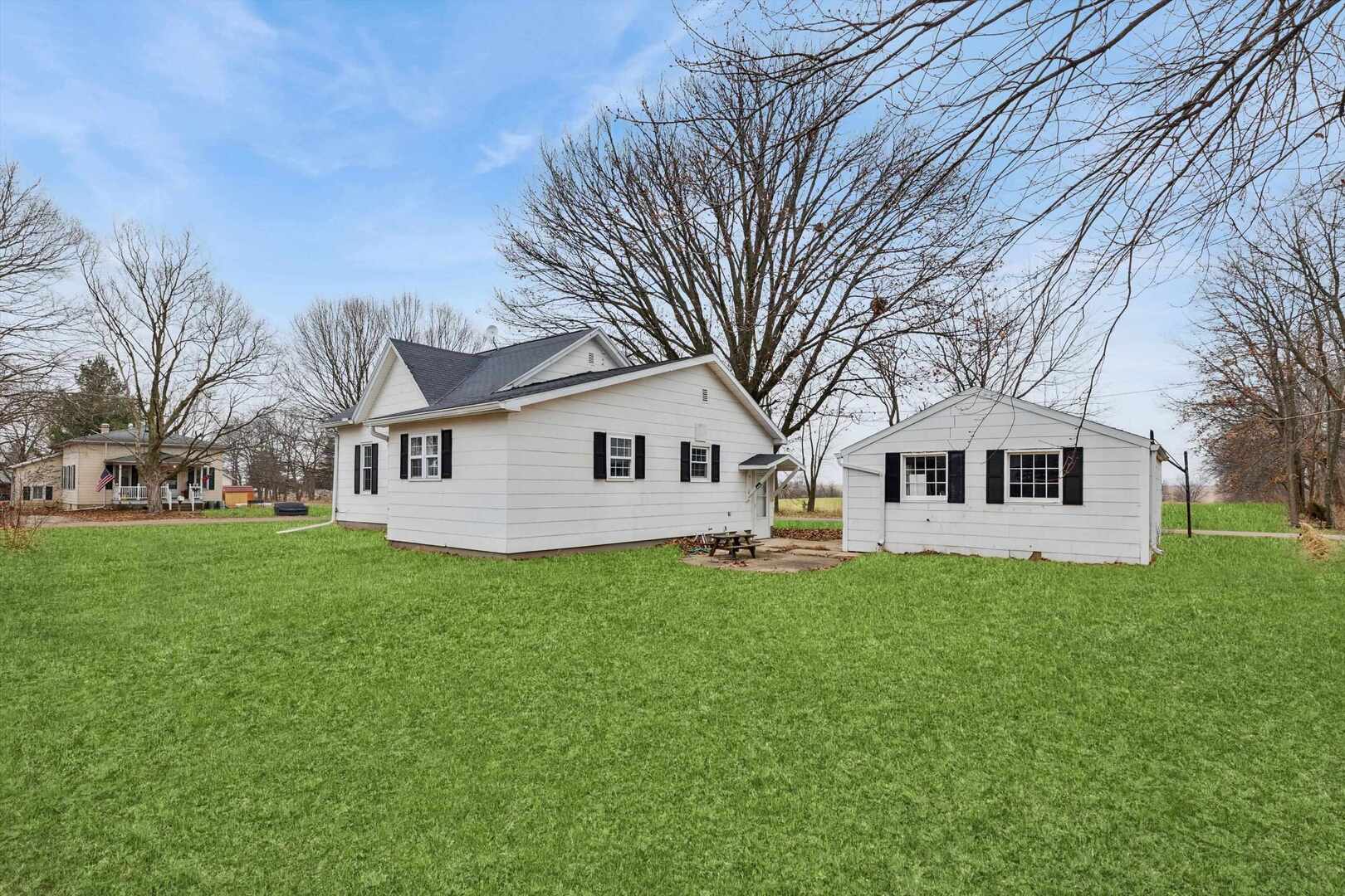 310 North Scott Street Alexis, IL 61412 - Photo 4 of 22 a white house that has a tree in front of it