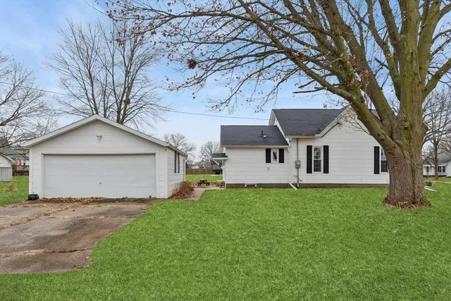 a front view of house with yard and trees