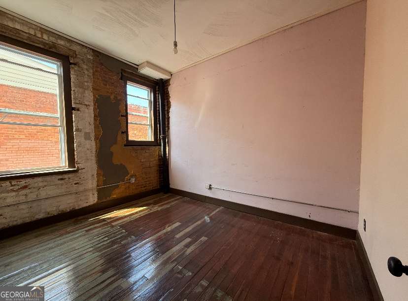 359 Railroad Street, Unit F Royston, GA 30662 - Photo 1 of 9 a view of an empty room with wooden floor and a window