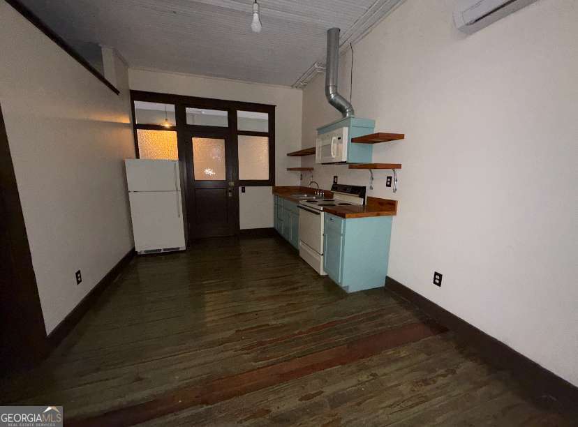 359 Railroad Street, Unit F Royston, GA 30662 - Photo 5 of 9 a kitchen with granite countertop a stove and a refrigerator