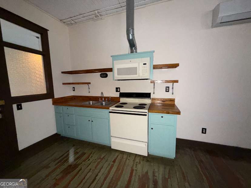 359 Railroad Street, Unit F Royston, GA 30662 - Photo 6 of 9 a kitchen with cabinets stove and wooden floor