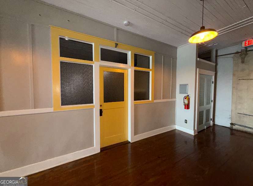 359 Railroad Street, Unit F Royston, GA 30662 - Photo 9 of 9 an empty room with wooden floor a chandelier