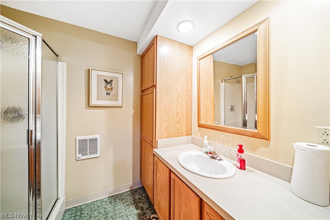 35510 Ridge Road Willoughby, OH 44094 - Photo 24 of 35 Bathroom featuring tile floors, vanity, mirror, and an enclosed shower