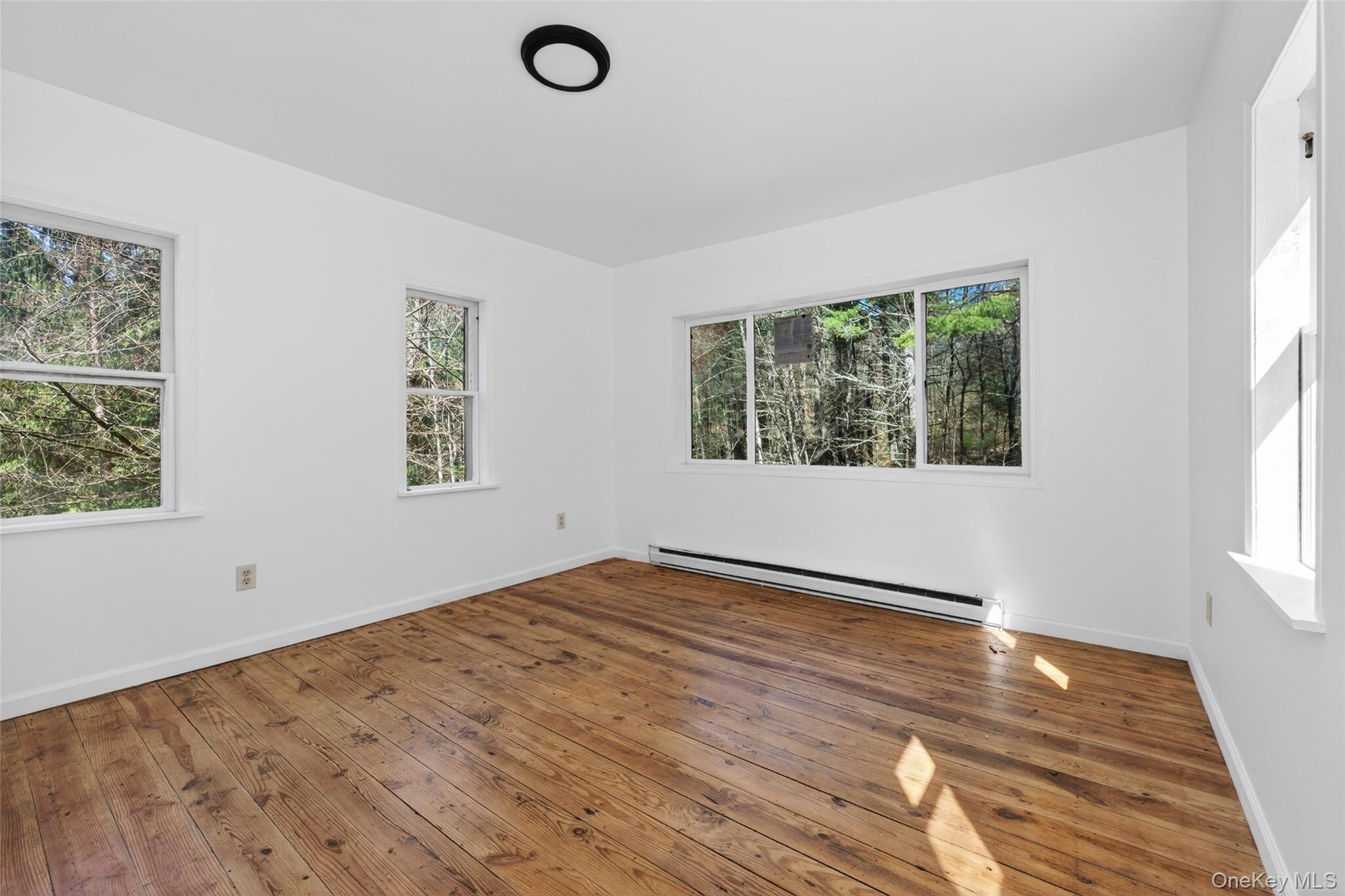 7 Highland Lake Road Eldred, NY 12732 - Photo 13 of 19 a view of empty room with wooden floor and fan
