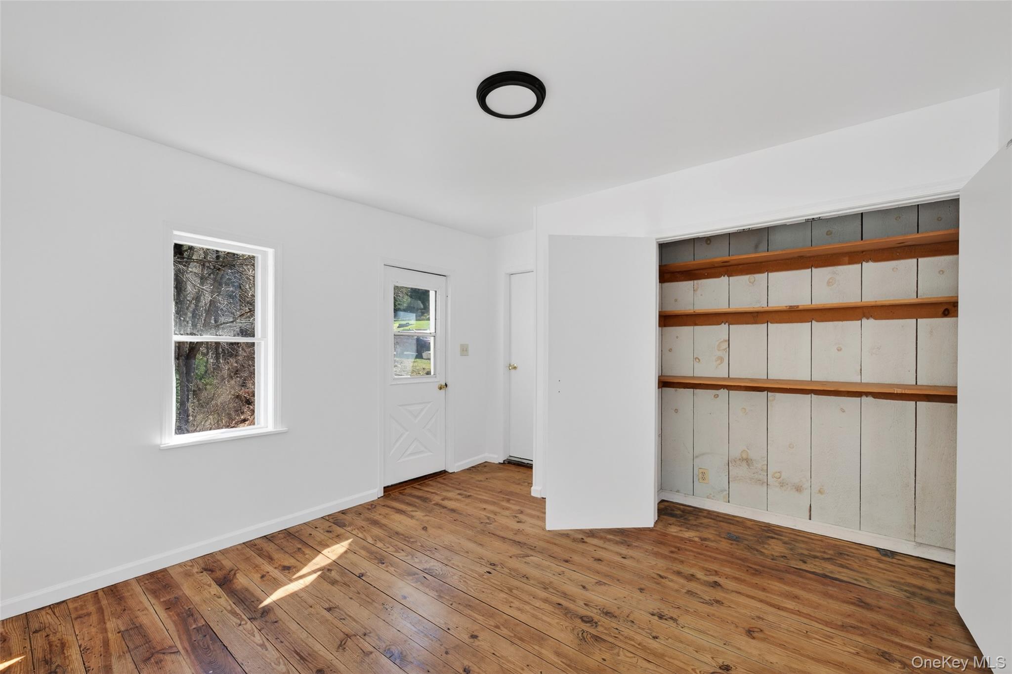 7 Highland Lake Road Eldred, NY 12732 - Photo 14 of 19 a view of an empty room with wooden floor and a window