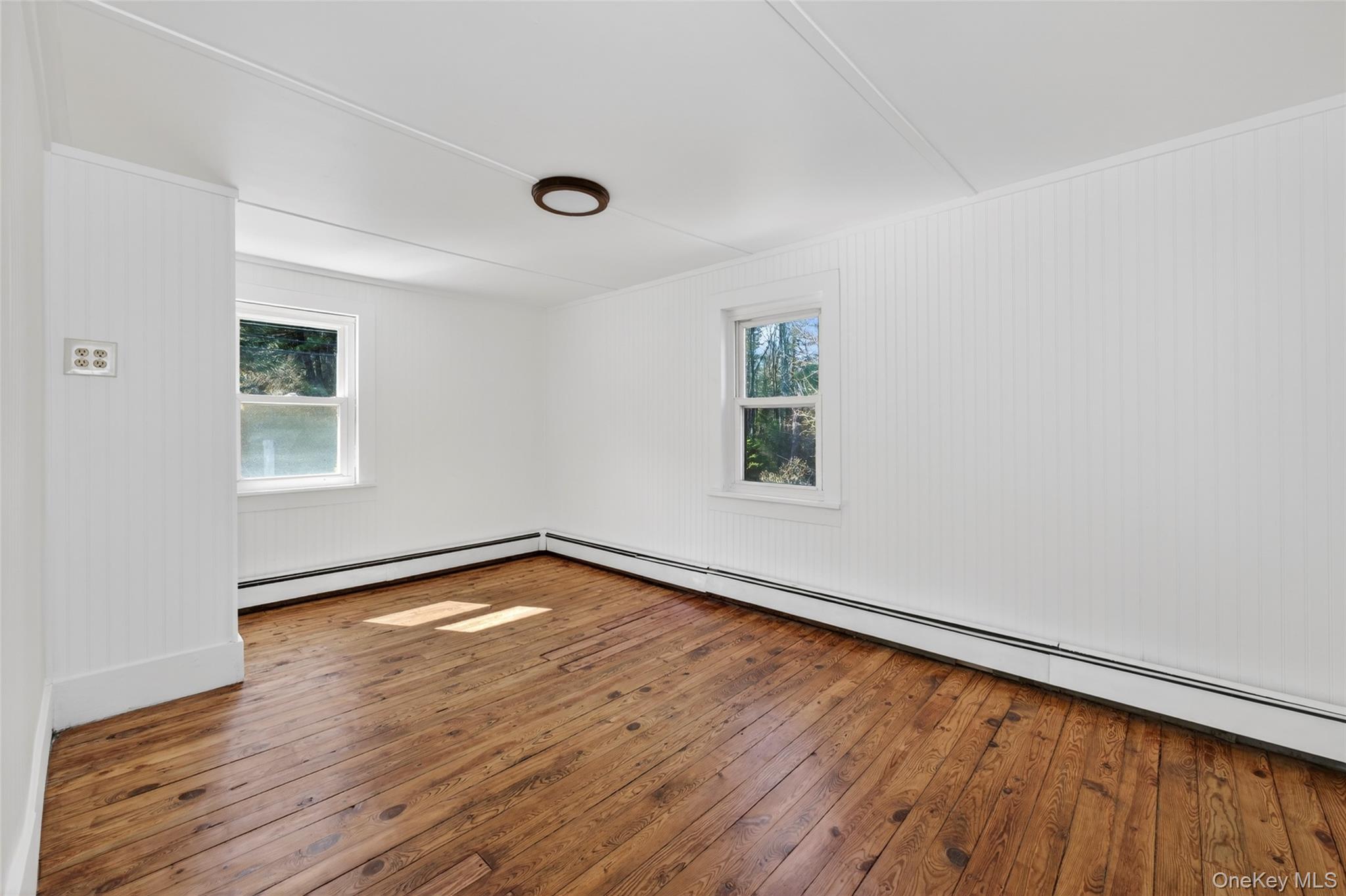 7 Highland Lake Road Eldred, NY 12732 - Photo 16 of 19 an empty room with wooden floor and windows