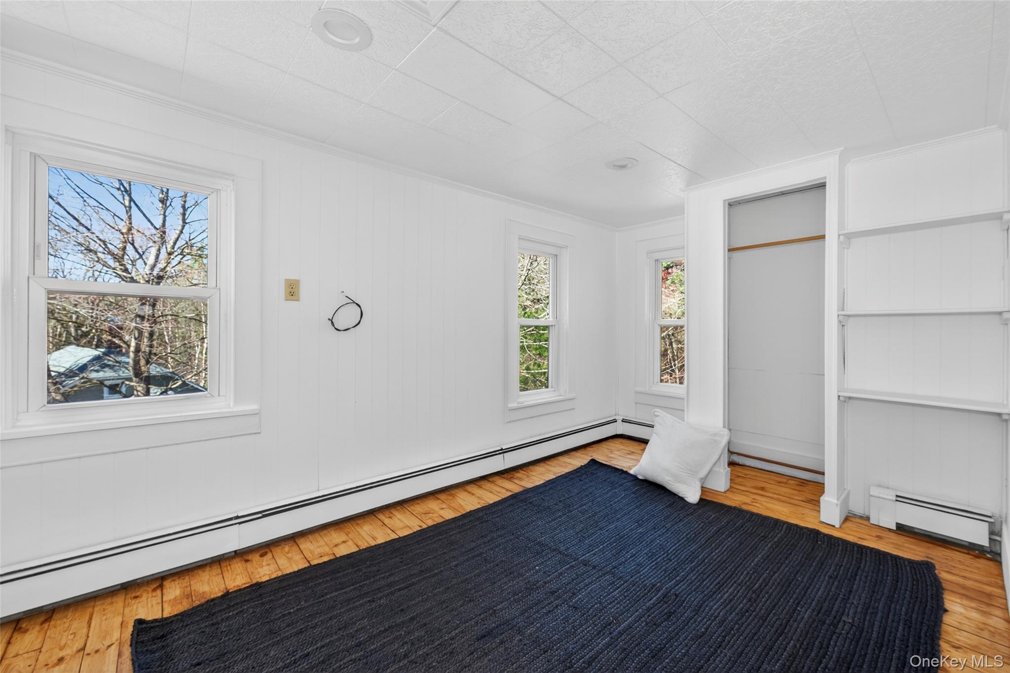 7 Highland Lake Road Eldred, NY 12732 - Photo 18 of 19 a view of empty room with wooden floor and fan