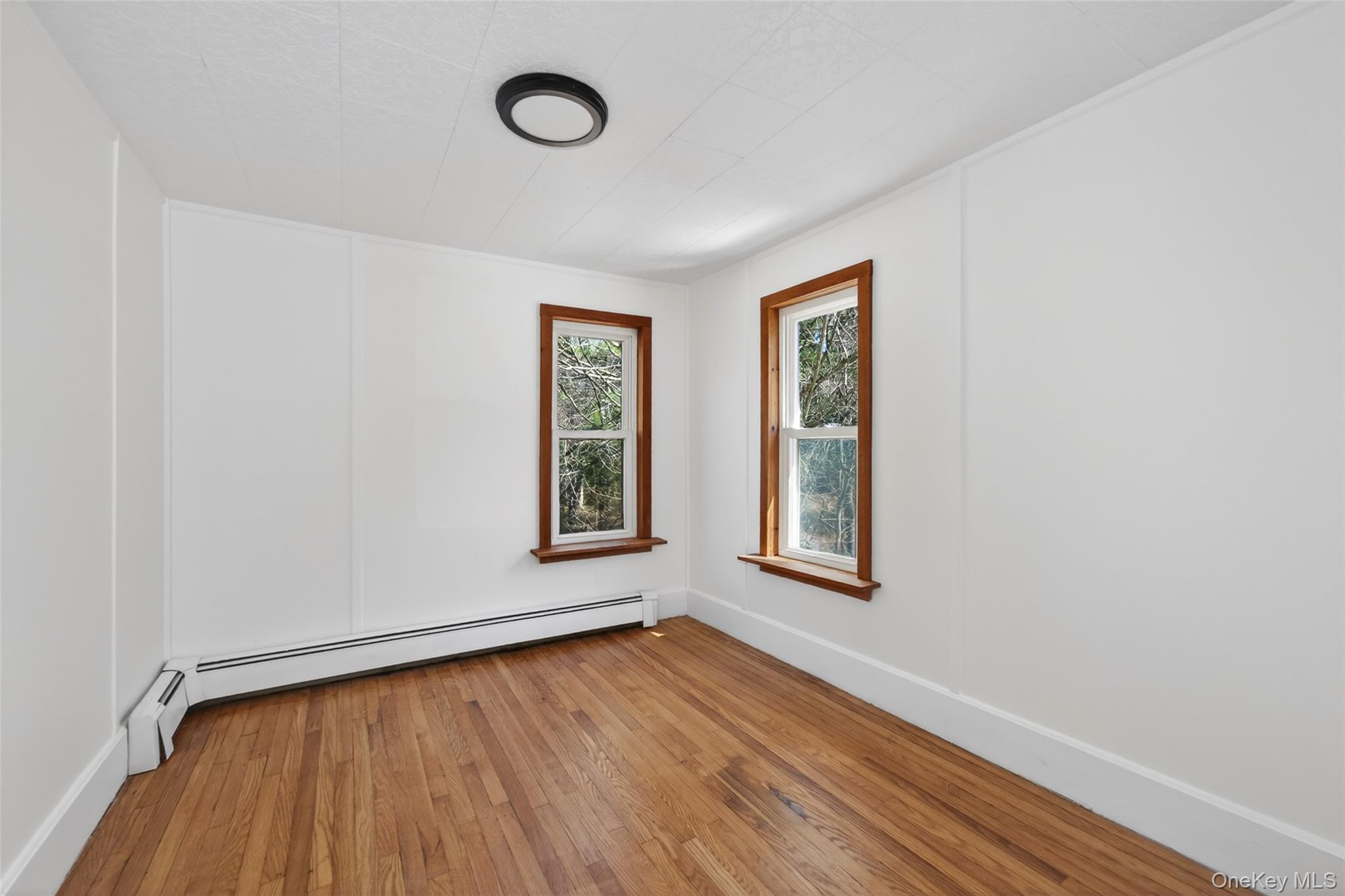 7 Highland Lake Road Eldred, NY 12732 - Photo 19 of 19 a view of an empty room with wooden floor and a window