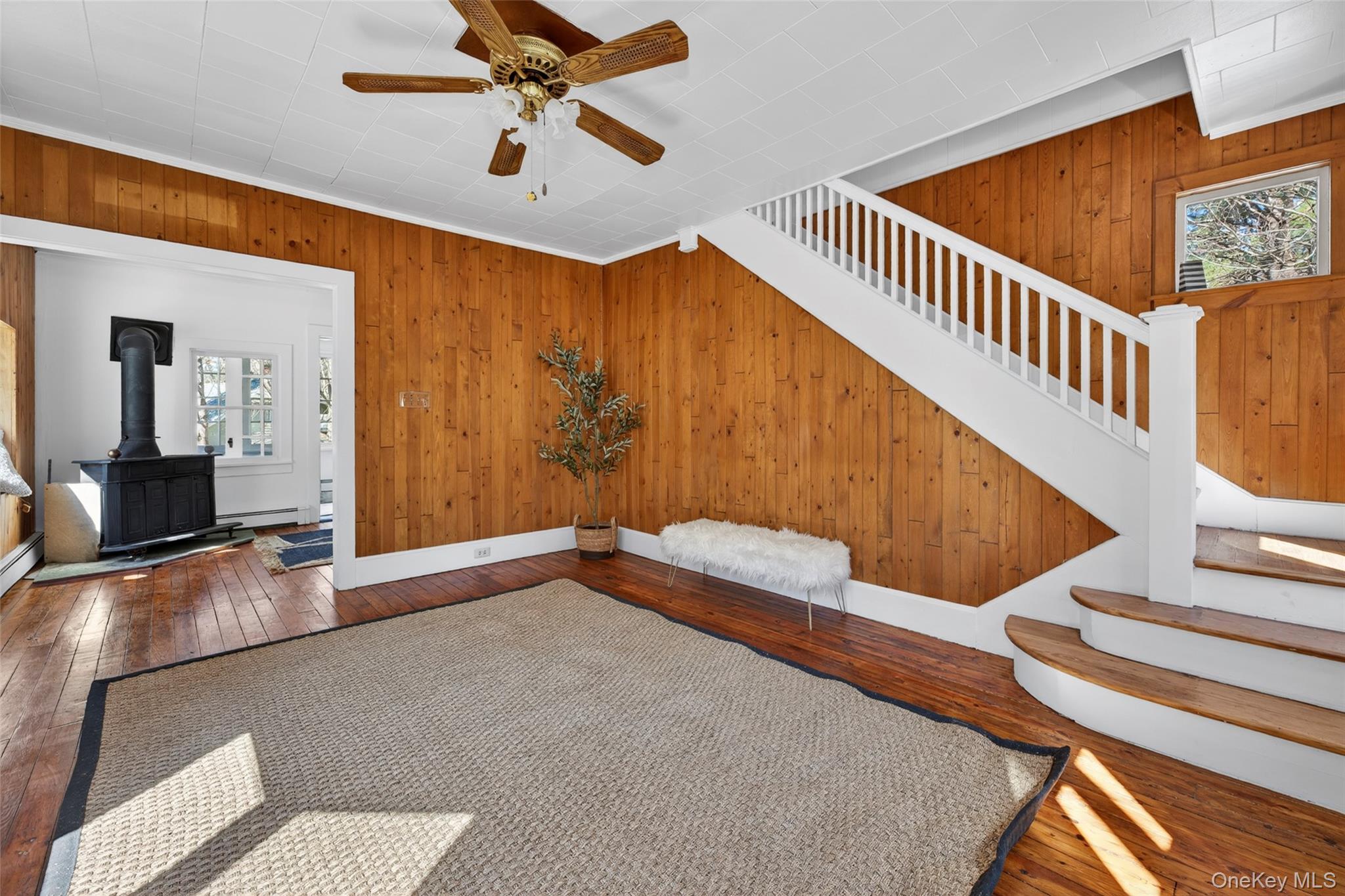 7 Highland Lake Road Eldred, NY 12732 - Photo 8 of 19 a view of a livingroom with wooden floor and a ceiling fan