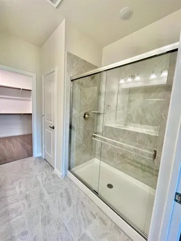 a bathroom with a glass shower door